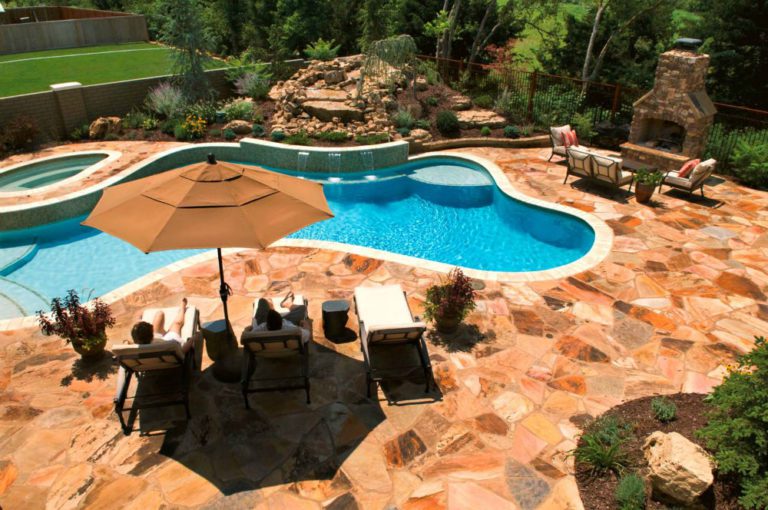 Flagstone pool deck and landscaping with waterfall