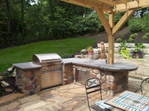 Stone outdoor grill patio space with countertop